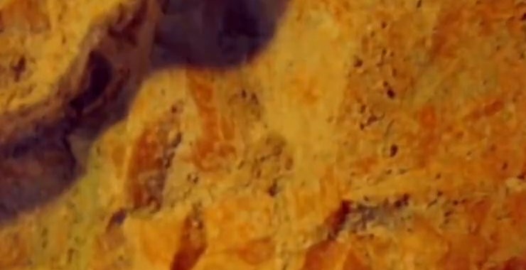Warm golden rock texture, amber tones
